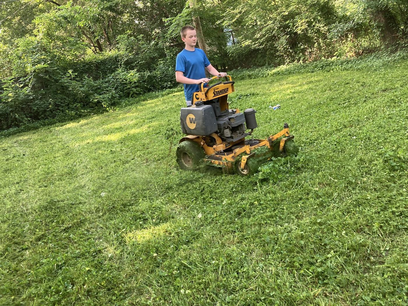 Mowing an overgrown slope on a stand-on mower